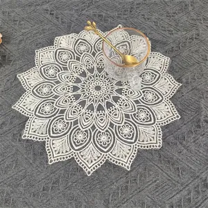 Detailed shot of a French vintage lace table mat with elegant floral embroidery