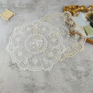 Retro circular embroidered lace placemats with delicate floral patterns on textured background