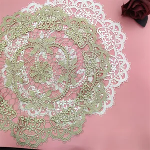 Macro shot showing the intricate details of vintage gold and white lace placemats.