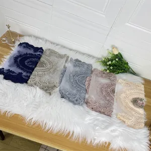 Detailed view of multiple colors of elegant lace embroidered hollow out table runners.
