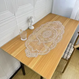 Detailed view of an elegant oval lace table runner with intricate floral embroidery