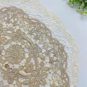 Macro detail of delicate floral embroidered lace placemat with scalloped edges