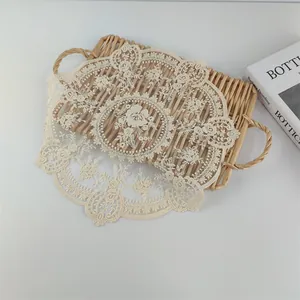 Macro detail of the intricate floral embroidery and mesh on a vintage lace placemat