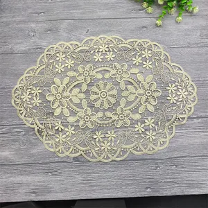 Intricate floral lace placemat with elegant scalloped edges on a wooden background