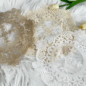 Exquisite detail of vintage circular embroidered lace placemats in soft elegant tones