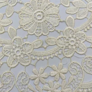 Detailed close-up view of an intricate cream floral lace embroidery pattern for home.