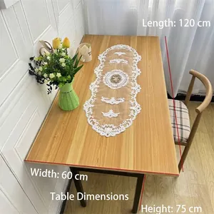 Elegant lace embroidered table runner with floral hollow-out design on wooden table