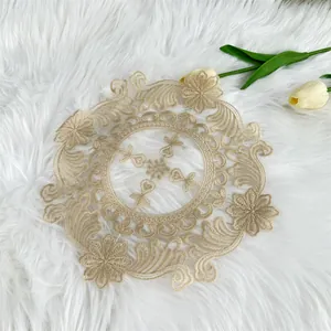 Detailed macro view of champagne embroidered milk silk doily on white faux fur background