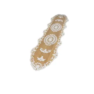 Elegant white lace embroidered table runner with hollow out floral patterns.