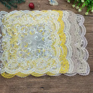 Dettaglio di tovagliette ricamate in pizzo retrò multicolore con motivi floreali.