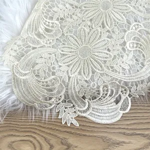 Detailed close-up shot of cream floral water-soluble lace mat for home decoration