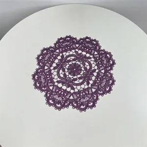 Detailed embroidery pattern on purple circular lace placemat for table decoration