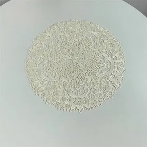 Elegant white embroidered round lace placemat with intricate floral hollow-out design