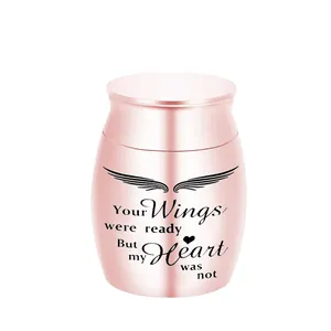 Detail of rose gold stainless steel memorial urn with engraved angel wings design