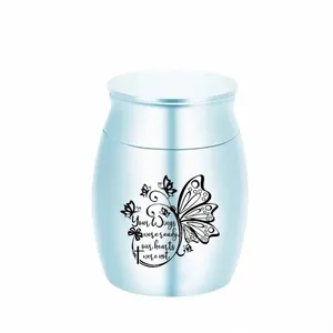 Small light blue metal memorial urn for pet ashes with butterfly engraving