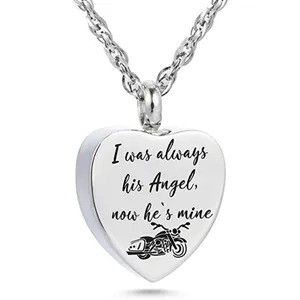 Detailed view of heart urn pendant with motorcycle design and memorial angel engraving