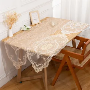 Elegant ivory lace table runner with intricate floral embroidery on a dining table
