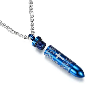 Close-up of blue bullet cremation urn pendant with cross and engraved prayer.