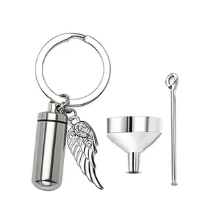 Stainless steel cylindrical cremation urn keychain with angel wing charm and funnel tools