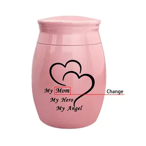 Close-up detail of pink heart cremation urn featuring My Mom My Hero My Angel text