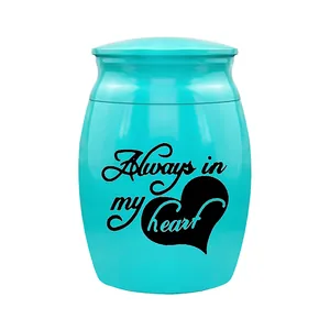 Detailed view of a teal cremation urn with Always in my heart and heart engraving