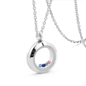 Close-up of a silver stainless steel locket necklace with colorful birthstones inside