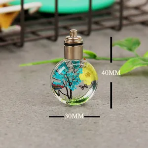 Detailed size view of round glass dried flower cremation urn pendant for memorial jewelry