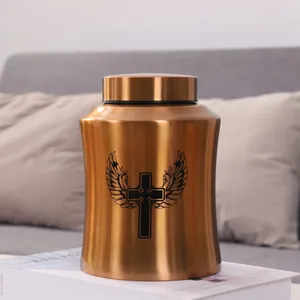 Detailed macro shot of a rose gold stainless steel pet urn with winged cross design