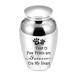 Macro view of polished silver pet cremation urn with paw print engraving