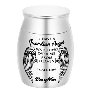 Close-up of the small stainless steel cremation urn featuring guardian angel engraving.