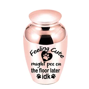Close-up of rose gold pet cremation urn with humorous Feeling Cute text engraving.