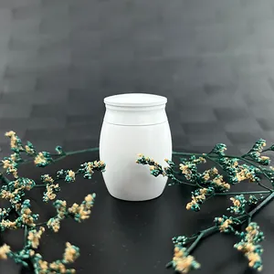 Detailed view of 40x30mm small white memorial urn jar for human or pet ashes