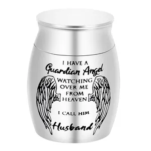 Detail showing the 'Guardian Angel' engraving on a small silver cremation urn