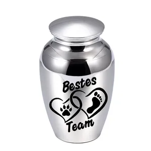 Silver pet cremation urn with paw print and Bestes Team engraving details.