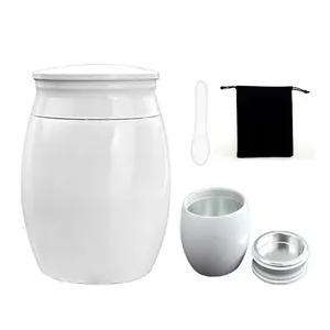 Small white metal memorial urn for human or pet ashes with velvet bag and spoon set