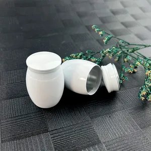 Detail view of small white souvenir urn showing the secure screw lid and interior