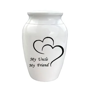 Detailed view of white ceramic cremation urn with heart and 'My Uncle' inscription.