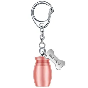 Close-up of pet memorial urn keychain with rose gold jar and Best Friend bone tag.