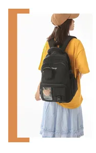 Detail view of model wearing a black Korean style padded backpack with bear ornament