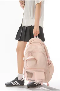 Soft pink Korean-style school backpack with a padded handle and cute mini pouch accessory