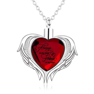 Detailed macro view of heart-shaped stainless steel cremation urn necklace with red crystal