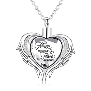 Detailed view of heart-shaped angel wing memorial urn necklace with engraved text