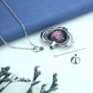 Memorial heart-shaped stainless steel cremation urn necklace with purple crystal inlay