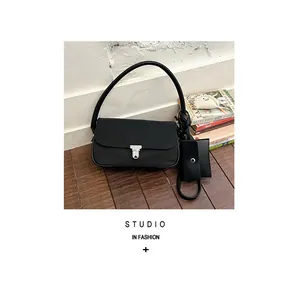 Black nylon underarm shoulder bag with metal lock and matching card pouch detail