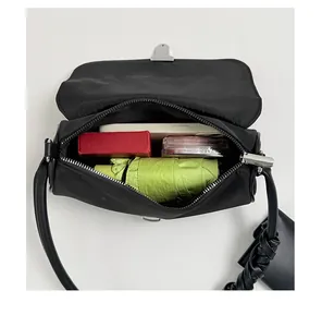 Macro view of black nylon shoulder bag interior showing spacious storage capacity