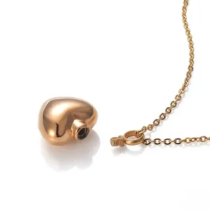 Detailed macro view of heart-shaped urn pendant showing the screw-top opening mechanism