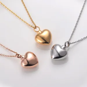 Detailed view of three polished heart cremation necklaces in gold, rose gold, and silver