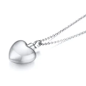 Close-up of a polished stainless steel heart-shaped memorial pendant with chain
