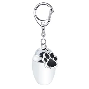 Polished stainless steel pet cremation urn keychain with decorative black paw print charm