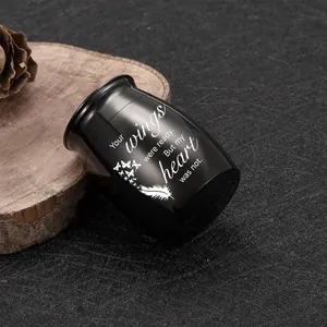 Black aluminum mini pet cremation urn engraved with memorial heart wings quote on wood